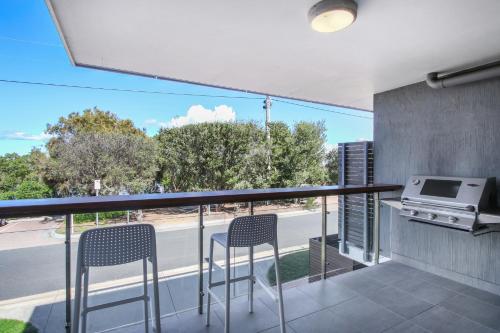 a balcony with a view of a street with trees at 5 Knots Metung in Metung