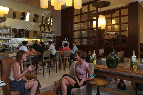 two women sitting in chairs in a restaurant at InterContinental Real Santo Domingo by IHG in Santo Domingo