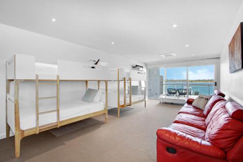 a living room with bunk beds and a couch at 5 Knots Metung in Metung