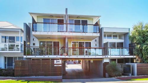 an apartment building with a large balcony on a street at 5 Knots Metung in Metung