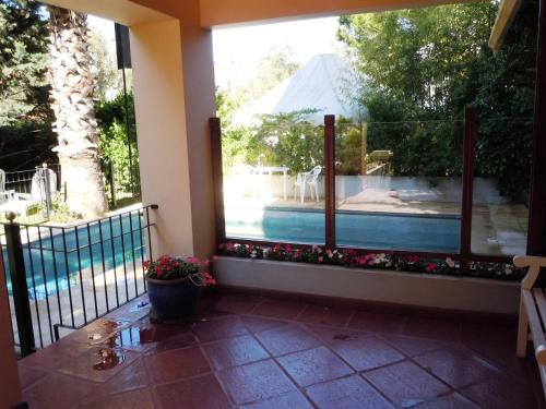 a balcony with a view of a swimming pool at Las Araucarias in Pinamar