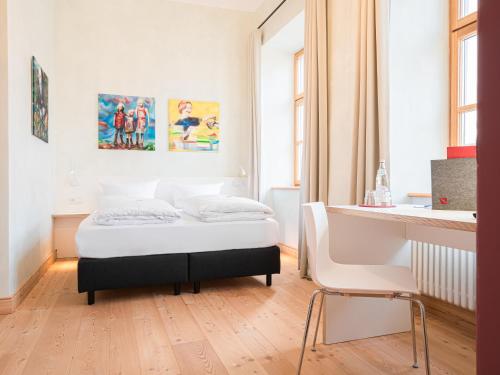 a bedroom with a bed and a table in it at Post Berching in Berching