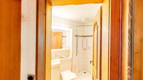 a bathroom with a toilet and a sink at Schweizerhof in Mels