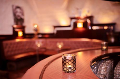 a candle holder on a table in a restaurant at Schweizerhof in Mels