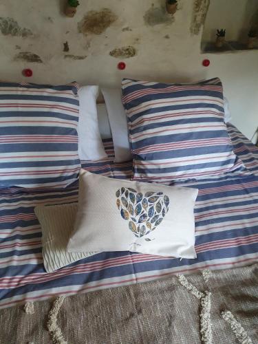 a bed with two pillows and a heart pillow at Au Nid de Caroline gîte 4 étoiles in Arette