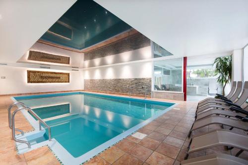 a swimming pool in a house with a swimming poolvisorvisor at Hotel Alpenland in Moso