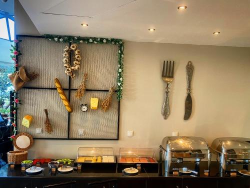 a kitchen with a counter with utensils on the wall at Aar Hotel & Spa Ioannina in Ioannina