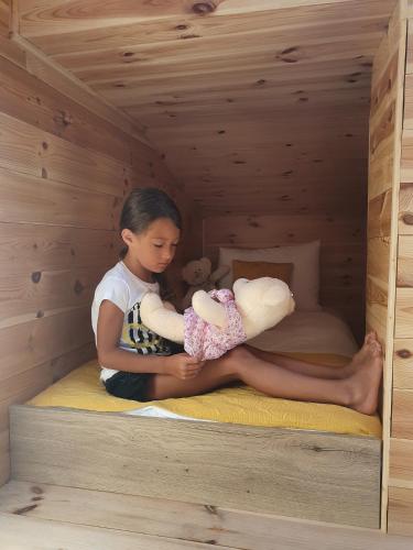 a young boy holding a baby in a wooden room at Dream House Hotel & Spa in Kolašin