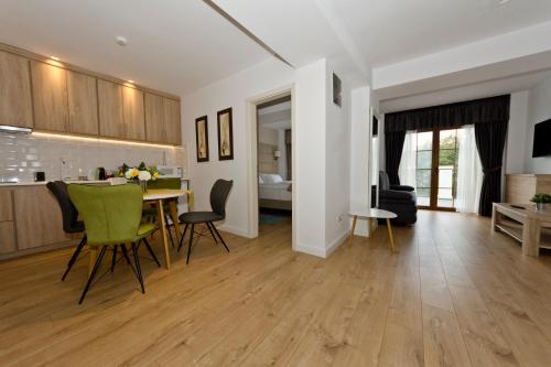 a kitchen and living room with a table and chairs at ApartamentS in Râşnov