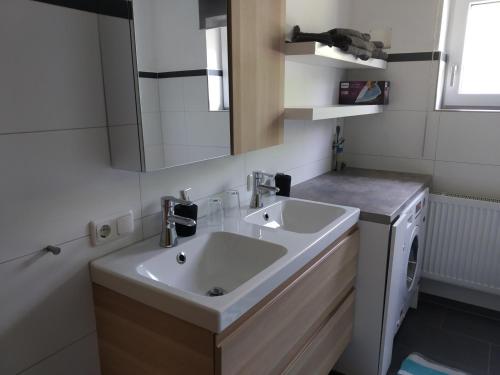 a bathroom with a sink and a washing machine at Ferienwohnung Betz in Riedenburg
