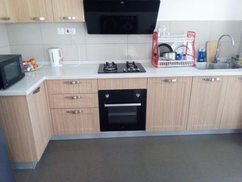 a kitchen with a stove and a sink at Sultan Palace in Kilifi