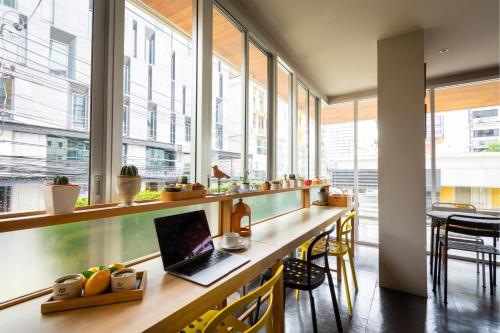 an office with a desk with a laptop on it at Lemontea Hotel Bangkok in Bangkok