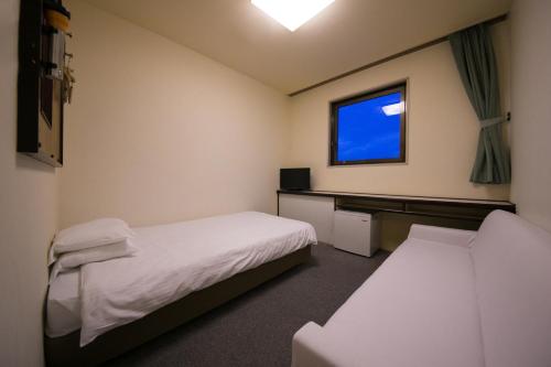 Katil atau katil-katil dalam bilik di Heiwadai Hotel Otemon