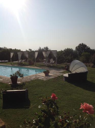 a swimming pool with a boat in a yard at La Canonica Di San Michele in Monteriggioni