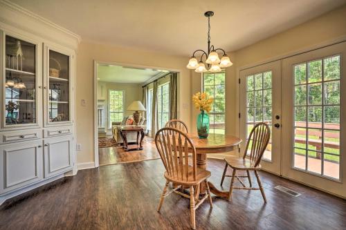 a dining room with a table and chairs at Pet-Friendly Suburban Escape with Deck and Grill! in Wando