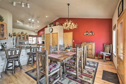 a kitchen and dining room with a table and chairs at Mtn-View Cabin with Deck, 3 Mi to Cripple Creek! in Cripple Creek