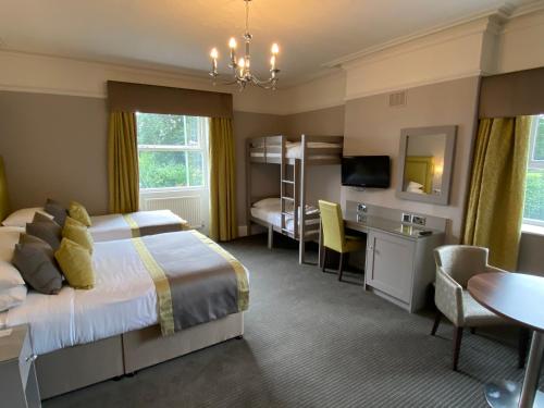 a hotel room with a bed and a desk and a bedroom at Cubley Hall in Penistone