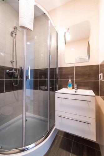 a bathroom with a shower and a sink at Willa Wena in Ustka