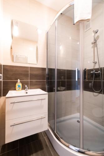 a bathroom with a shower and a sink at Willa Wena in Ustka