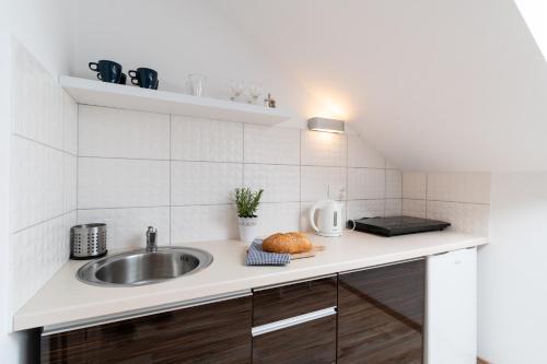 a kitchen with a sink and a counter top at Willa Wena in Ustka