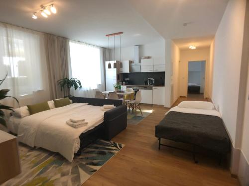a bedroom with a large bed and a living room at AM City Apartment 24h Self-Check-In, Free Parking, U-Bahn 350m, Netflix in Nuremberg