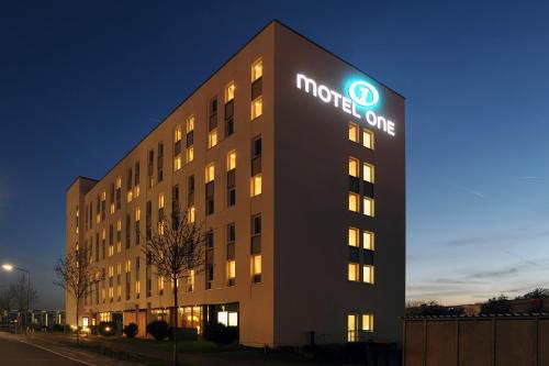 
a large building with a clock on the side of it at Motel One Frankfurt Airport in Frankfurt/Main
