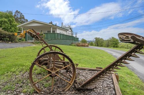 a statue of a train on the side of a road at Mole Creek Cabins in Mole Creek