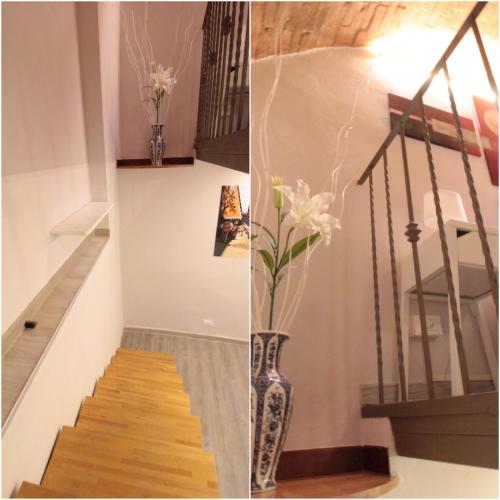 a stairway with a vase with flowers in it at Suite al Duomo in Siena