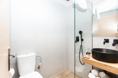 a bathroom with a toilet, sink, and shower at Ciel Living Athens in Athens
