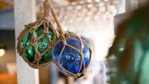 a pair of blue glass balls hanging from a rope at Hotel Am Medemufer in Otterndorf