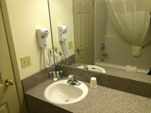 a bathroom counter with a sink and a mirror at Wheatland Hotel in Strathmore