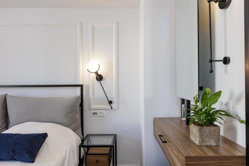 a bedroom with a bed and a table with a plant at Jo An Palace in Rethymno Town