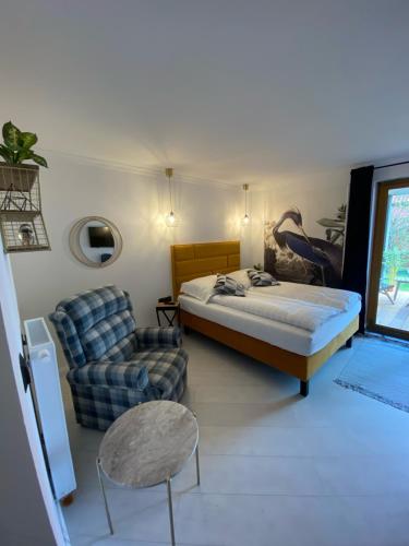 a bedroom with a bed and a couch and a chair at Nova Apartamenty Rewa in Rewa