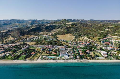 an aerial view of a beach with houses at Blue Carpet Luxury Suites in Pefkochori