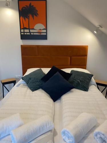 a bed with white sheets and pillows on top of it at Nova Apartamenty Rewa in Rewa