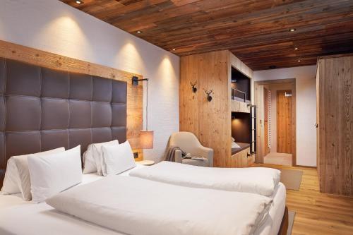 フラッハウにあるPromi Alm Flachau - Luxus Chaletsのベッドルーム(ベッド2台、テレビ付)