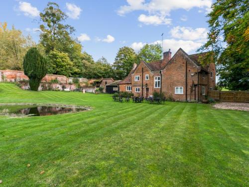 a large grassy yard in front of a house at Secluded Mansion Retreat - Expansive Private Oasis - Pass the Keys in Burnham