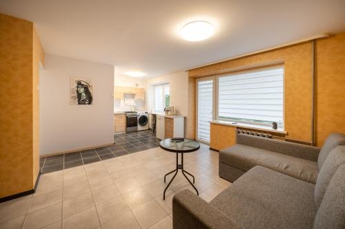 a living room with a couch and a table at Wonderful Apartment in the City Center in Šiauliai