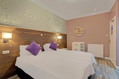 a hotel room with a bed and a dresser at Kinloch Arms Hotel in Carnoustie