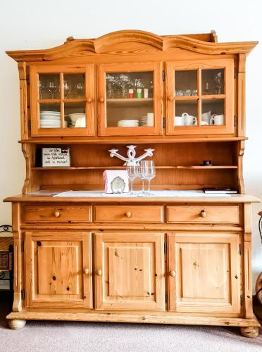 a wooden hutch with glass doors on top at Haus am Römerbad in Bad Kleinkirchheim