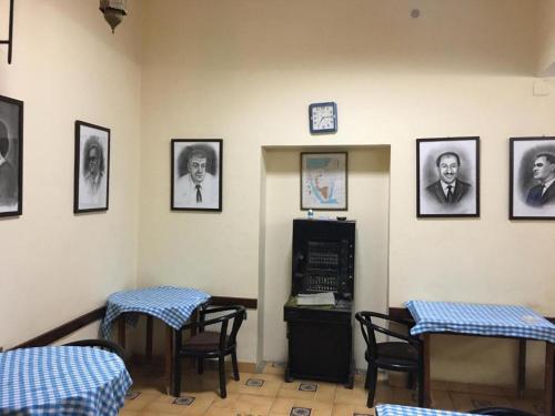 a waiting room with two tables and a clock on the wall at Tulip Hotel in Cairo