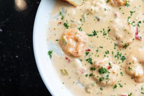 a white bowl of shrimpowder with a piece of bread at Hotel Indigo Baton Rouge Downtown by IHG in Baton Rouge