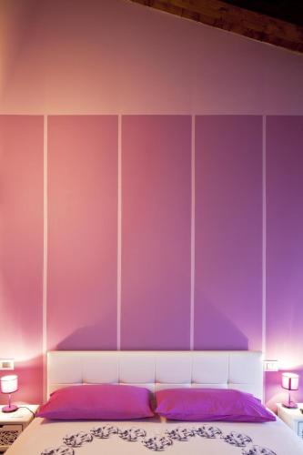 a purple bedroom with a bed with purple walls at La Corte D'Emilio B&B in Vignola