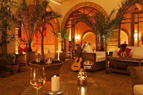 a hotel room with a bed and a guitar at Riad Chbanate in Essaouira