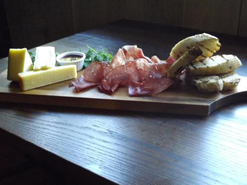 a plate of food with meat and cheese on a table at Hadley Bowling Green Inn in Droitwich