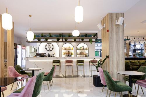 a restaurant with tables and chairs and a bar at Jo An Palace in Rethymno Town