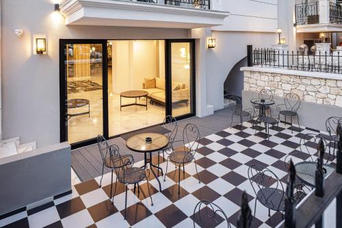 a restaurant with tables and chairs on a checkered floor at Jo An Palace in Rethymno Town