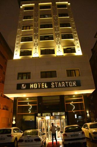 un bâtiment avec des voitures garées devant dans l'établissement Starton Hotel, à Ankara