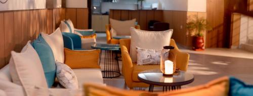 a lobby with chairs and a table with a candle at Urban Hotel Nouakchott in Nouakchott