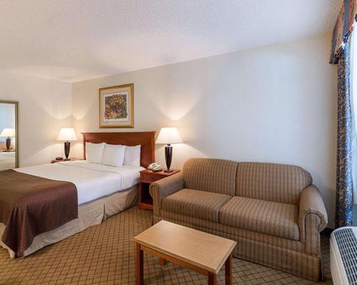 a hotel room with a bed and a couch at GreenTree Hotel & Extended Stay I-10 FWY Houston, Channelview, Baytown in Channelview